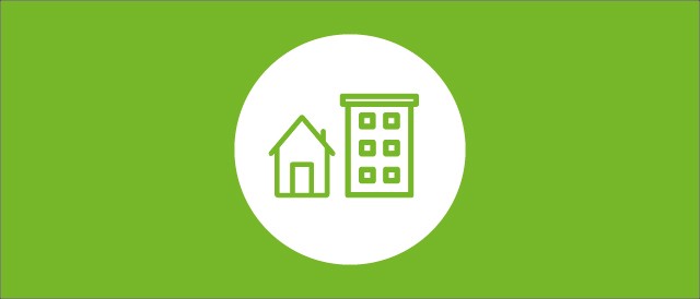 Runder weißer Kreis mit Häusern als Icon auf grünem Hintergrund